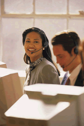 woman wearing headset sitting in front of computer