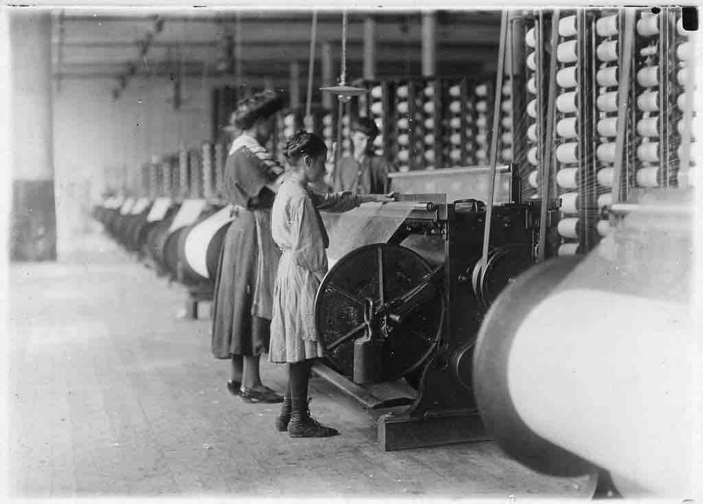 Girls running warping machines in Loray Mill, Gastonia, N.C. by Lewis Hine, 1908.