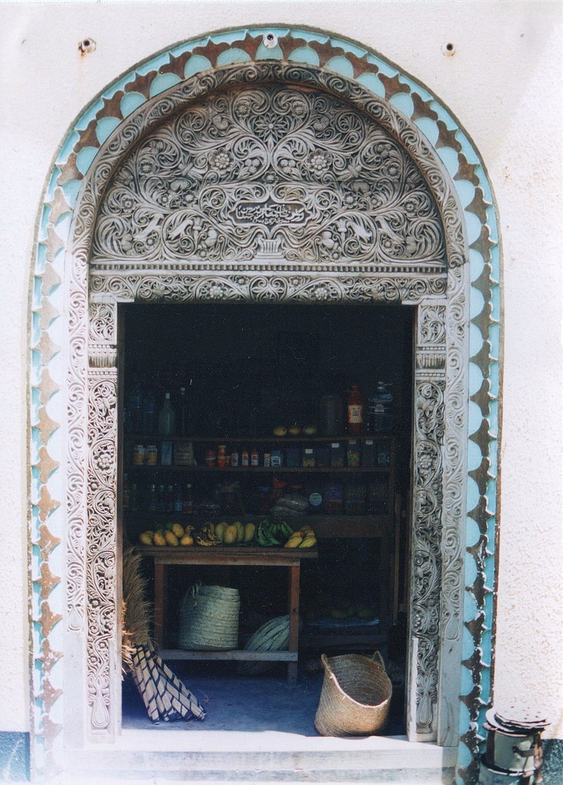 
Swahili Arabic script on a carved wooden door (open) at Lamu in Kenya      

