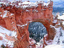 A large opening in red red with snow on top