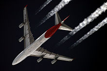 Underside planform view of an in-flight 747. Under each of the two wings are two engines.