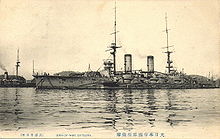 Large warship at rest on the sea.